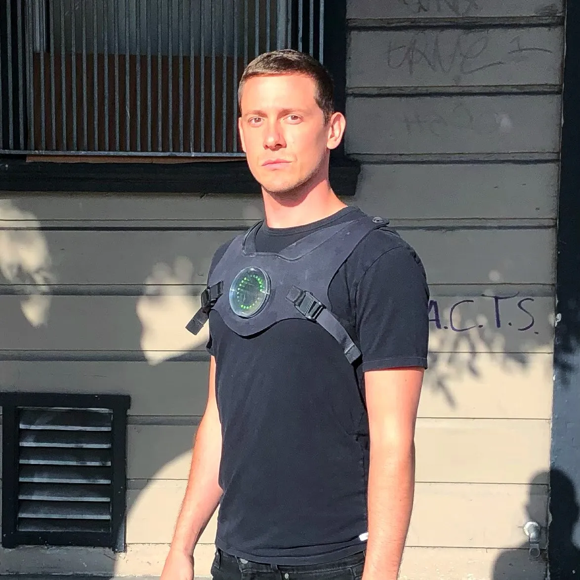 The author on a brick sidewalk in a black T-shirt and the Holovest harness, disc dark, looking at the camera